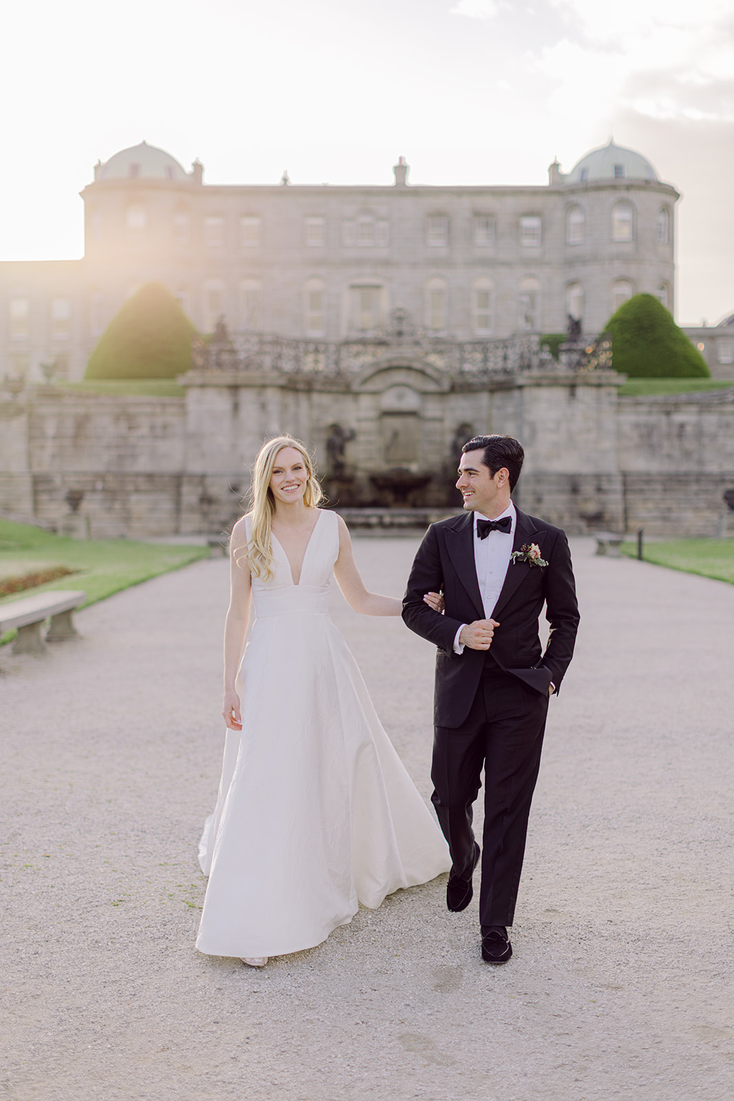 Wedding couple walking in estate gardens