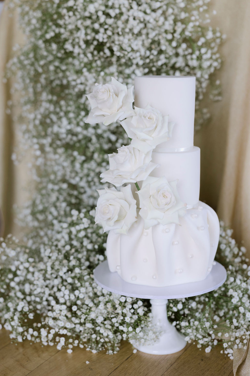 White wedding cake with sugar roses