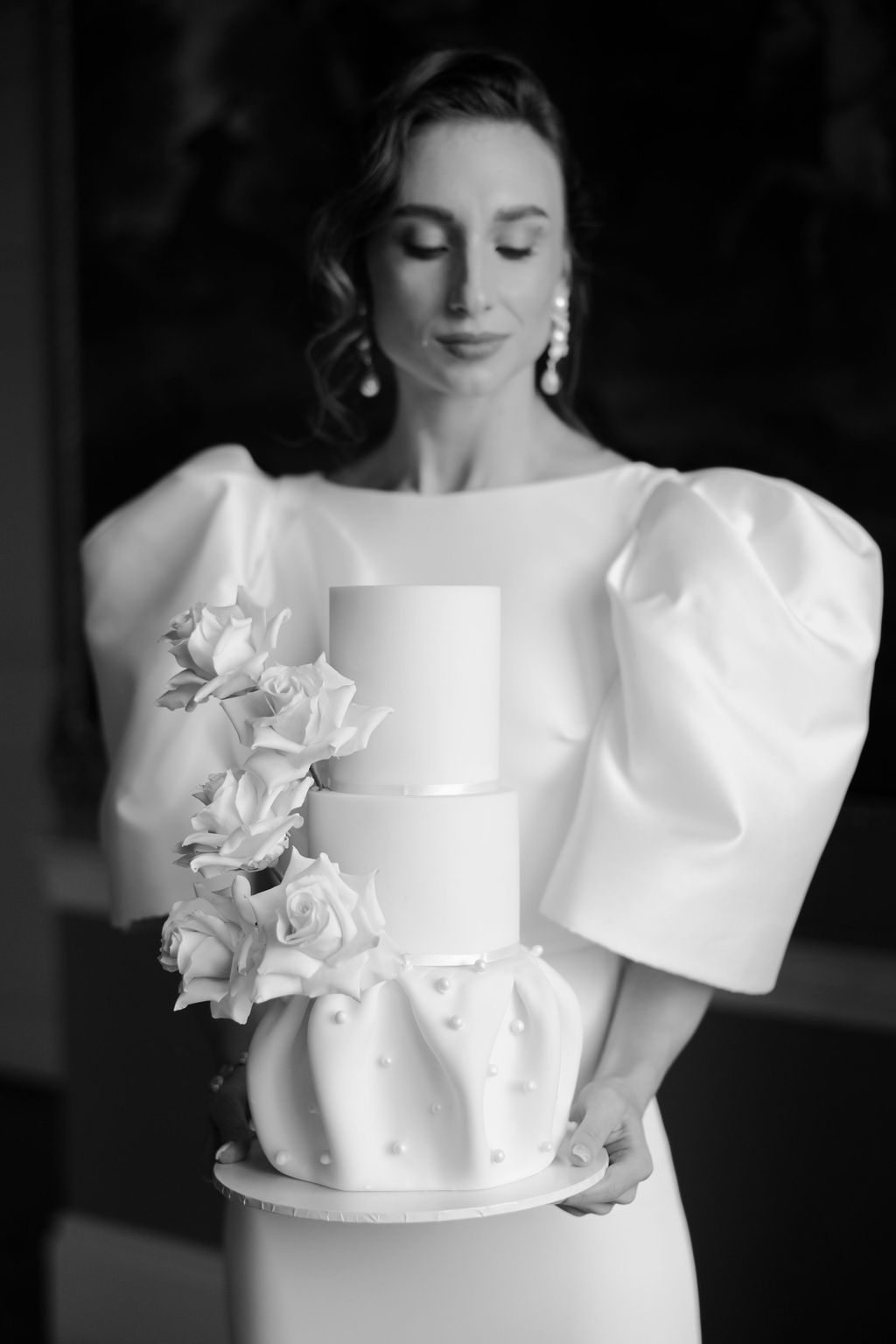 Bride holding wedding cake