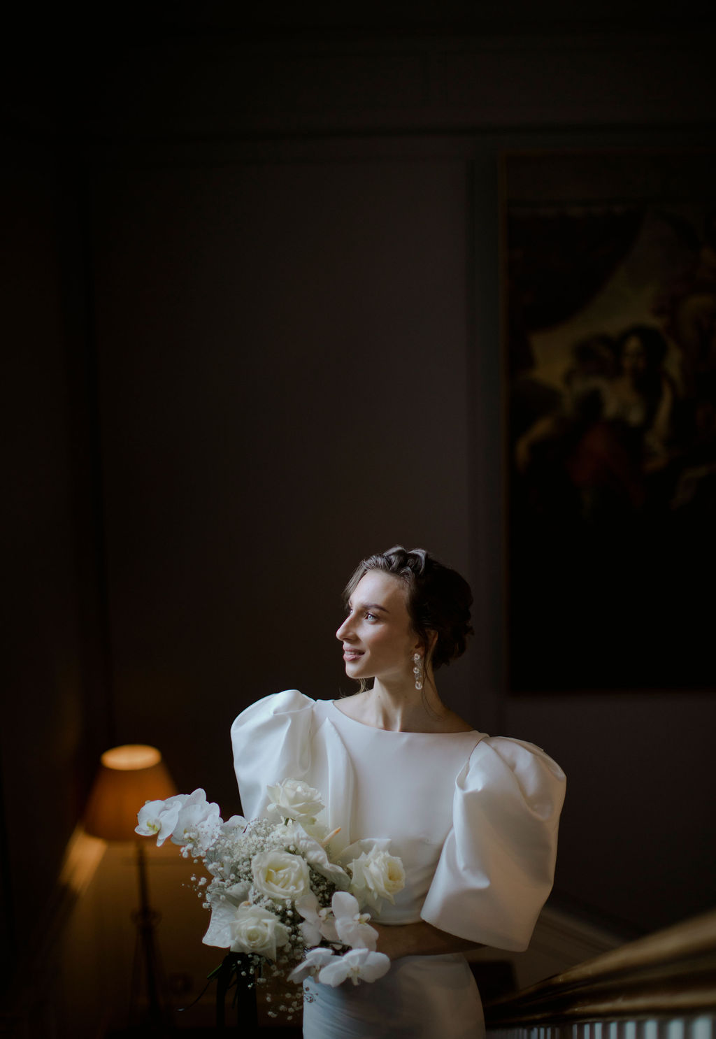 Bride on stairs with wedding bouquet