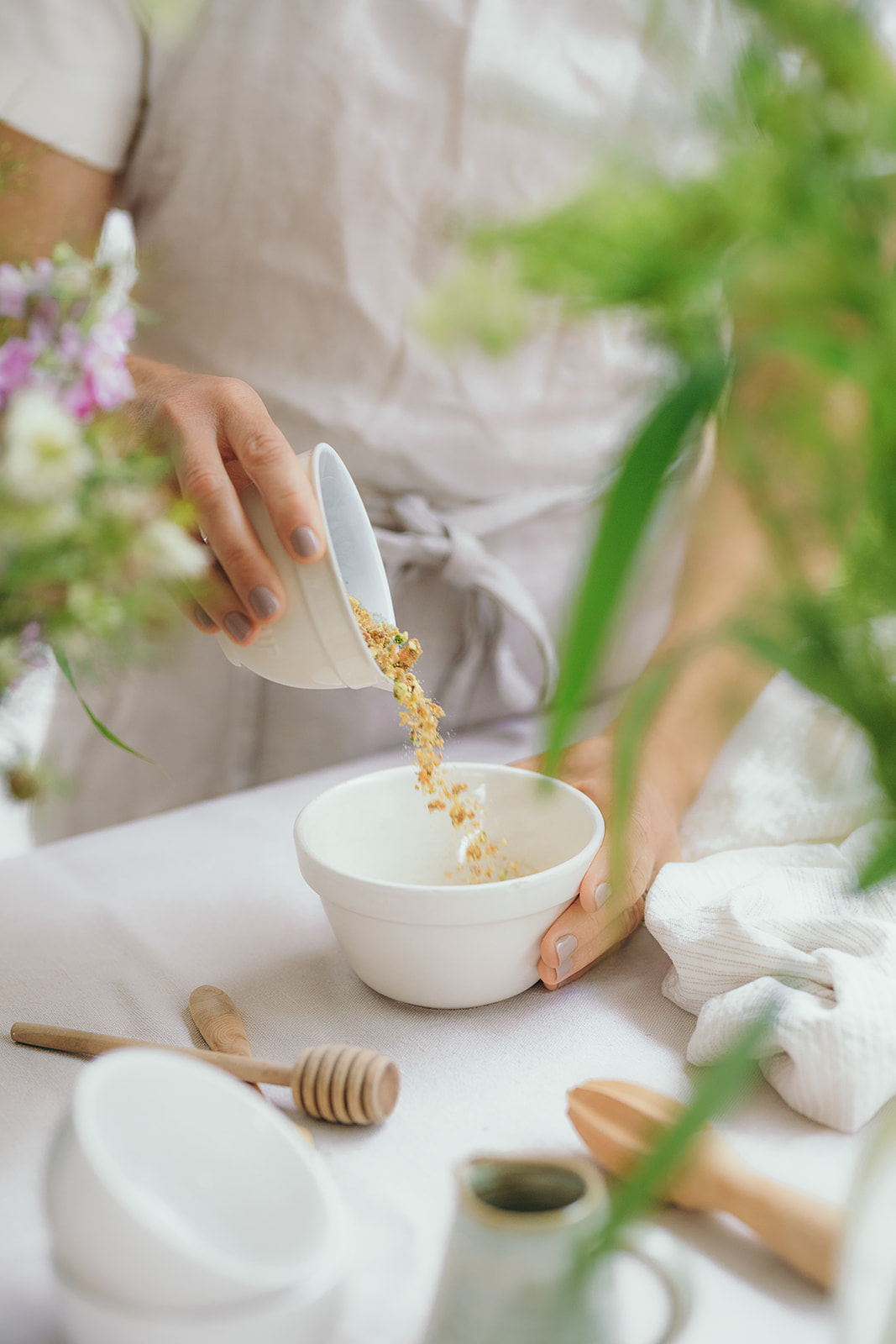 Baker pouring nut praline into bowl