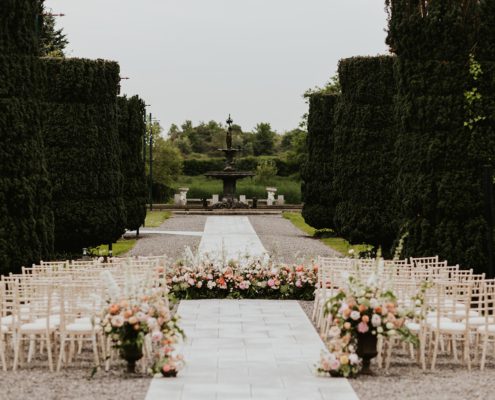 Outdoor wedding set up with beautiful aisle florals